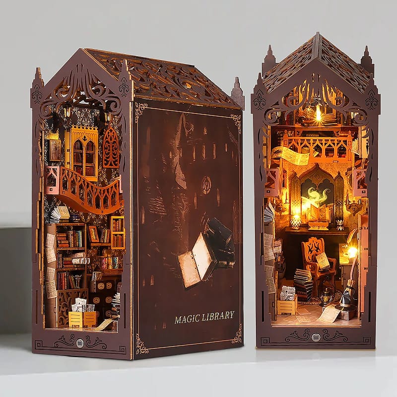 Assembled DIY Magic House Book Nook Kit glowing with warm LED lights